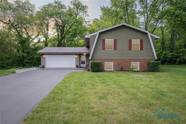 3480 Circle Dr, Delta, OH 43515 - view of front of house featuring a garage, driveway, a front yard, a gambrel roof, and view of scattered trees