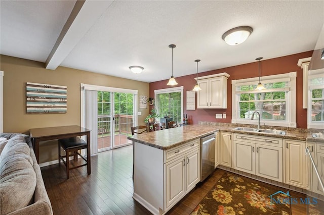 3480 Circle Dr, Delta, OH 43515 - kitchen featuring dishwasher, a sink, cream cabinets, open floor plan, and beamed ceiling