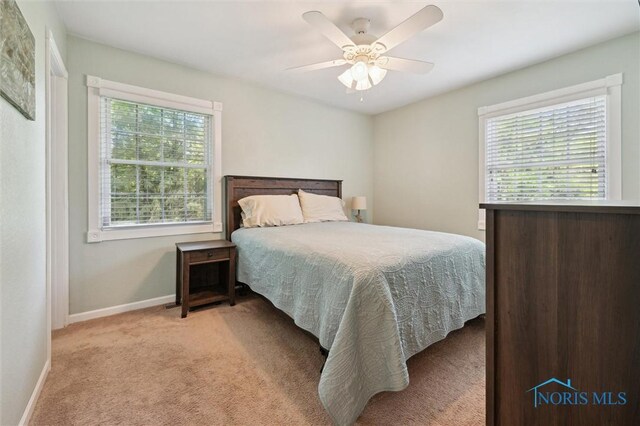3480 Circle Dr, Delta, OH 43515 - bedroom with light colored carpet, baseboards, and ceiling fan