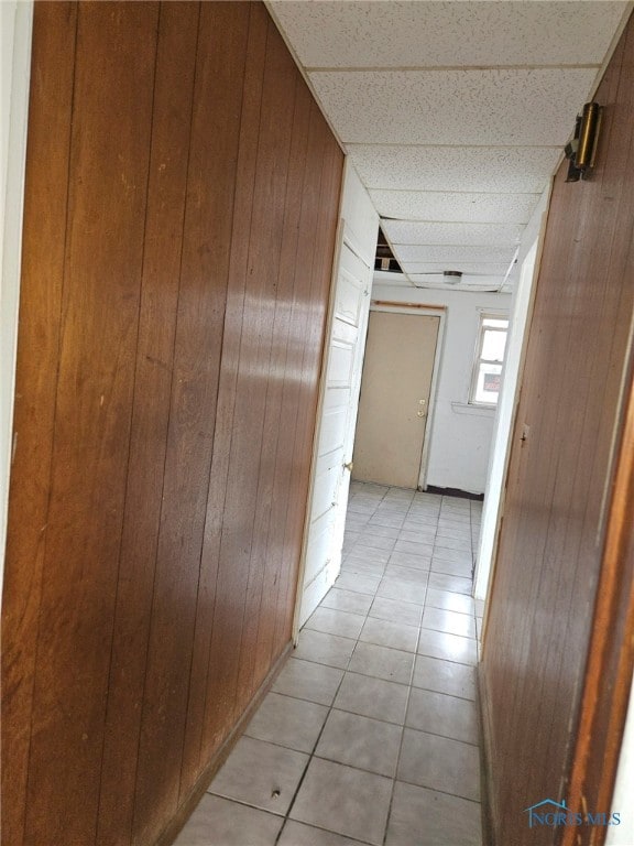 149 Oswald St, Toledo, OH 43605 - hallway with wooden walls, light tile patterned floors, and a paneled ceiling