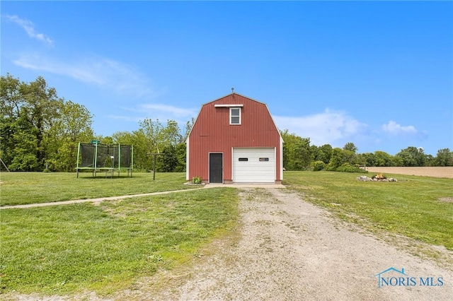 22227 US Highway 20a, West Unity, OH 43570 - view of barn with driveway, a trampoline, and a yard