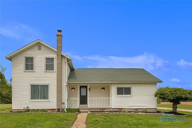 22227 US Highway 20a, West Unity, OH 43570 - traditional-style house with a porch, a front yard, and a chimney