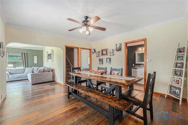22227 US Highway 20a, West Unity, OH 43570 - dining room featuring arched walkways, a ceiling fan, wood-type flooring, and stairs