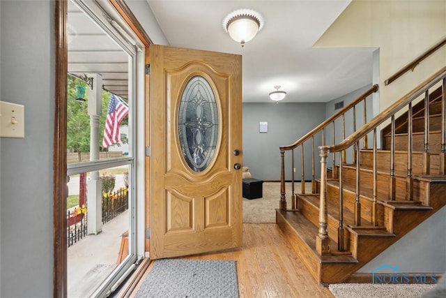 219 Illinois Dr, Bryan, OH 43506 - foyer with wood finished floors, plenty of natural light, and stairs