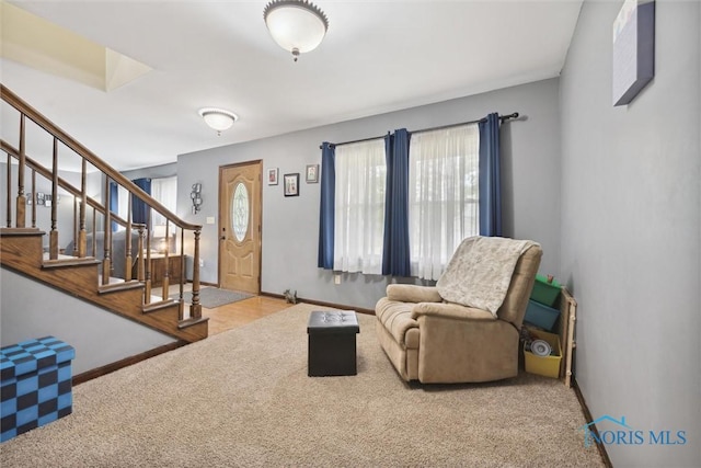 219 Illinois Dr, Bryan, OH 43506 - carpeted living area featuring stairway and baseboards