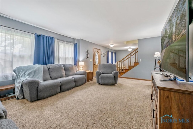 219 Illinois Dr, Bryan, OH 43506 - carpeted living room featuring stairs and baseboards