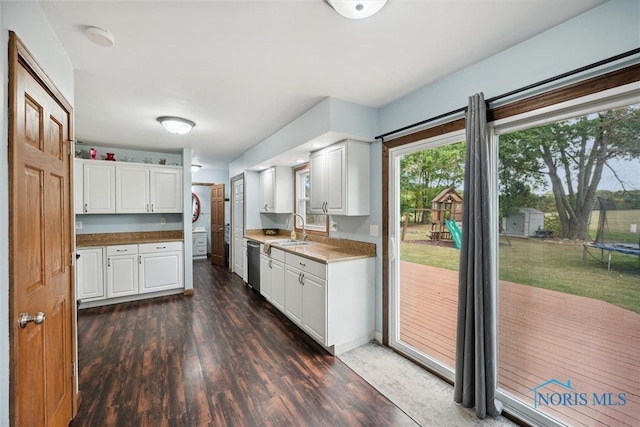 219 Illinois Dr, Bryan, OH 43506 - kitchen featuring a sink, dark wood-style flooring, stainless steel dishwasher, and white cabinets
