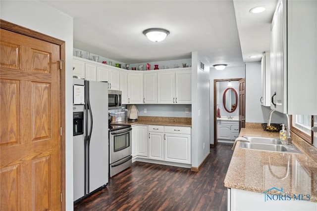 219 Illinois Dr, Bryan, OH 43506 - kitchen with stainless steel appliances, dark wood-type flooring, white cabinetry, and light stone counters