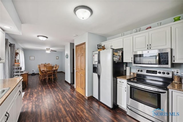 219 Illinois Dr, Bryan, OH 43506 - kitchen featuring stainless steel appliances, white cabinetry, dark wood-style flooring, ceiling fan, and baseboards