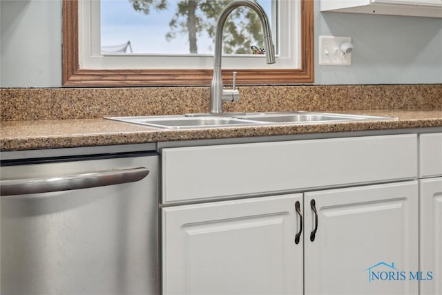 219 Illinois Dr, Bryan, OH 43506 - kitchen with stainless steel dishwasher, a sink, and white cabinets