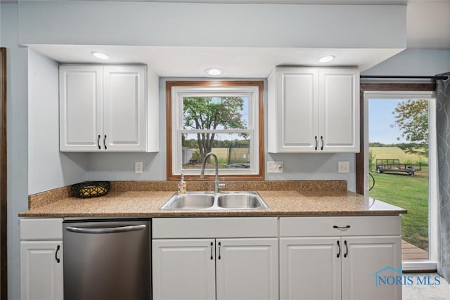 219 Illinois Dr, Bryan, OH 43506 - kitchen featuring stainless steel dishwasher, a sink, and white cabinets
