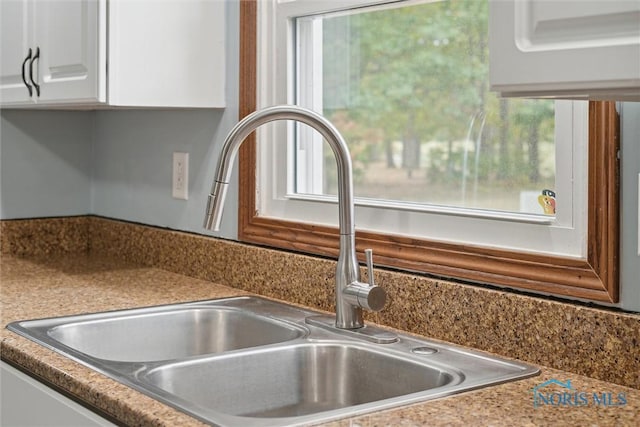 219 Illinois Dr, Bryan, OH 43506 - kitchen view of a sink and white cabinetry