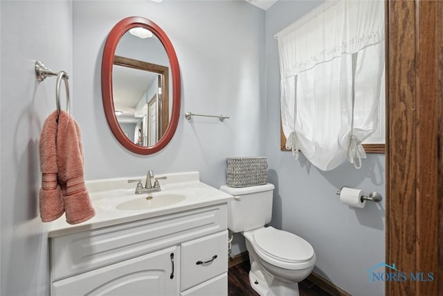 219 Illinois Dr, Bryan, OH 43506 - half bath featuring vanity, toilet, and baseboards