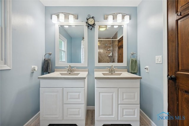 219 Illinois Dr, Bryan, OH 43506 - full bathroom featuring two vanities, a shower, and baseboards