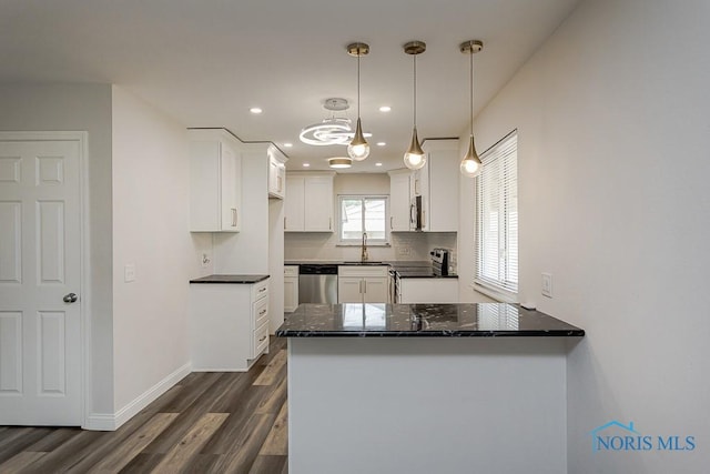 1048 Richland St, Maumee, OH 43537 - kitchen with stainless steel appliances, a sink, a peninsula, dark wood-style flooring, and white cabinetry