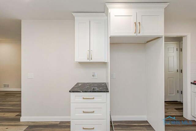 1048 Richland St, Maumee, OH 43537 - kitchen with dark wood finished floors, baseboards, white cabinets, and dark stone countertops