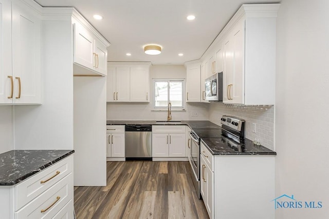 1048 Richland St, Maumee, OH 43537 - kitchen featuring stainless steel appliances, a sink, dark wood-type flooring, recessed lighting, and backsplash