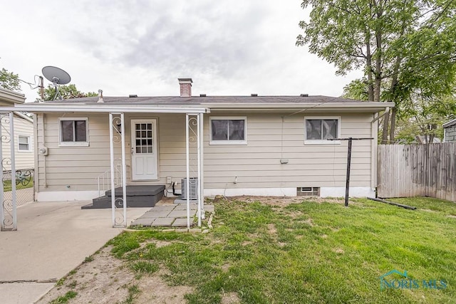 1048 Richland St, Maumee, OH 43537 - back of property with a patio area, central AC unit, and a chimney