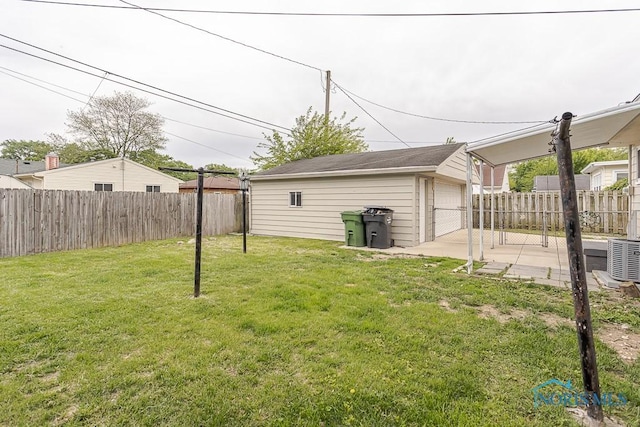 1048 Richland St, Maumee, OH 43537 - view of yard with an outdoor structure, a detached garage, a patio, and central AC unit