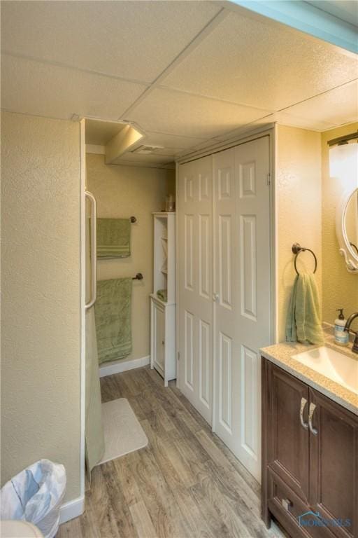 1367 Junior Dr, Maumee, OH 43537 - bathroom featuring wood finished floors, vanity, a shower, baseboards, and a textured wall