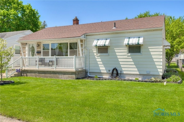 1367 Junior Dr, Maumee, OH 43537 - back of house with a chimney, a yard, and a shingled roof