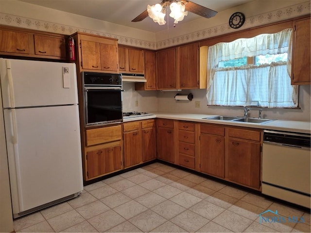 1100 Cherry Ln, Findlay, OH 45840 - kitchen with white appliances, a sink, brown cabinets, under cabinet range hood, and ceiling fan