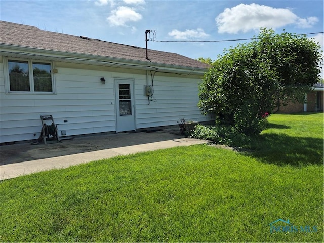 1100 Cherry Ln, Findlay, OH 45840 - rear view of house with a lawn, a patio area, and roof with shingles