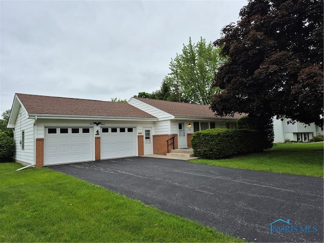 1100 Cherry Ln, Findlay, OH 45840 - single story home featuring driveway, a garage, a front lawn, and brick siding