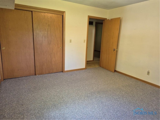 1100 Cherry Ln, Findlay, OH 45840 - unfurnished bedroom featuring baseboards, a closet, and carpet
