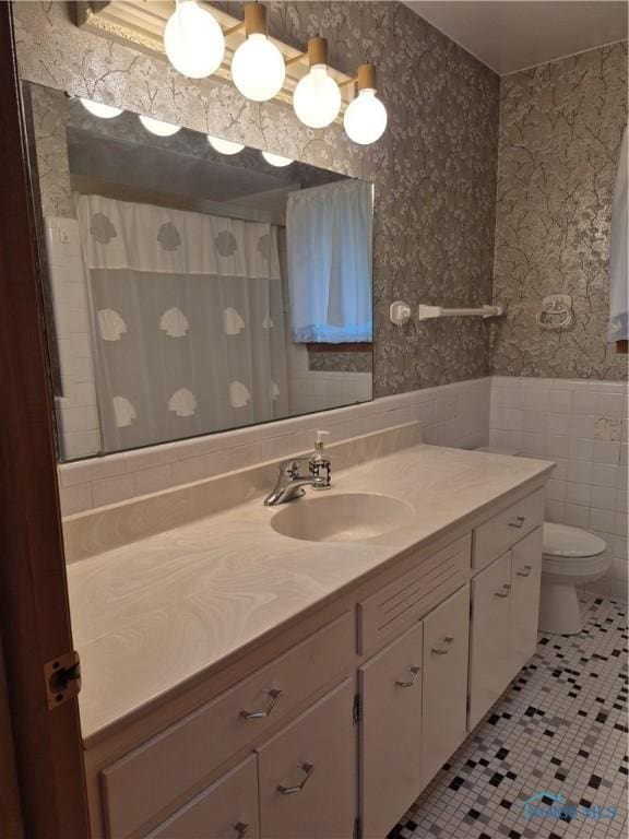 1100 Cherry Ln, Findlay, OH 45840 - full bathroom with wallpapered walls, vanity, tile patterned flooring, toilet, and wainscoting