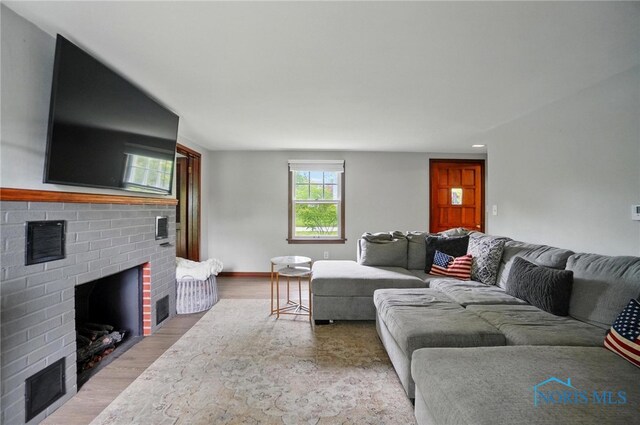 314 E 2nd St, Perrysburg, OH 43551 - living room featuring a brick fireplace, wood finished floors, baseboards, and recessed lighting