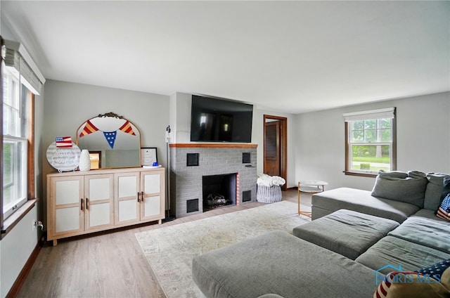 314 E 2nd St, Perrysburg, OH 43551 - living area featuring wood finished floors, a fireplace, and baseboards