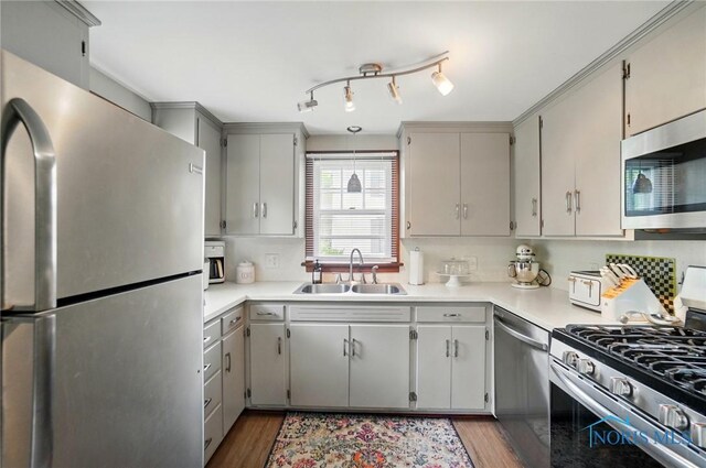 314 E 2nd St, Perrysburg, OH 43551 - kitchen featuring stainless steel appliances, a sink, wood finished floors, light countertops, and gray cabinets