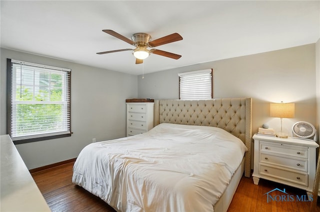 314 E 2nd St, Perrysburg, OH 43551 - bedroom featuring multiple windows, dark wood-style floors, baseboards, and a ceiling fan