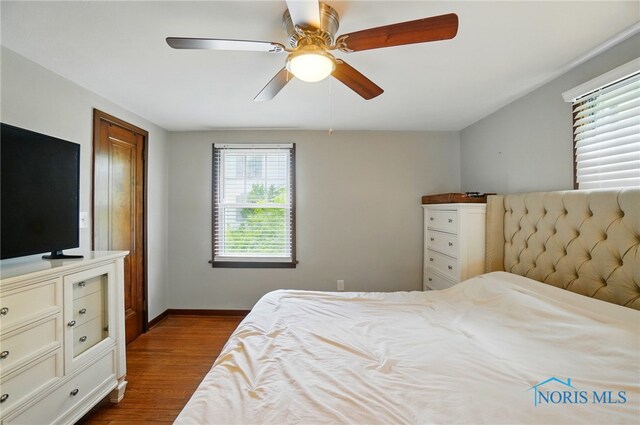 314 E 2nd St, Perrysburg, OH 43551 - bedroom featuring dark wood finished floors, a ceiling fan, and baseboards