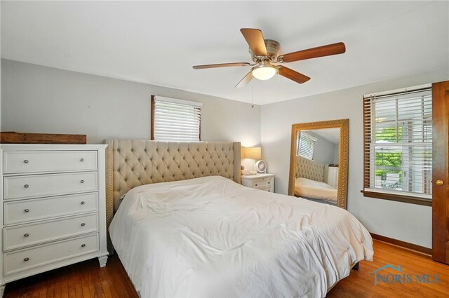 314 E 2nd St, Perrysburg, OH 43551 - bedroom with multiple windows, dark wood finished floors, baseboards, and a ceiling fan