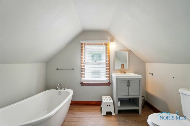 314 E 2nd St, Perrysburg, OH 43551 - full bathroom featuring a freestanding bath, wood finished floors, toilet, vanity, and vaulted ceiling