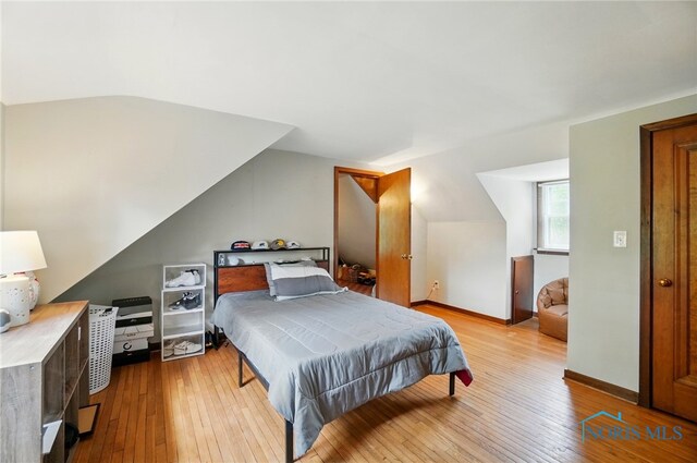 314 E 2nd St, Perrysburg, OH 43551 - bedroom featuring wood-type flooring, lofted ceiling, and baseboards