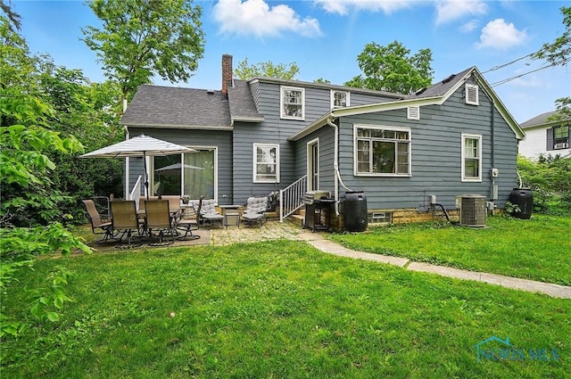 314 E 2nd St, Perrysburg, OH 43551 - rear view of property featuring a chimney, entry steps, a yard, central AC unit, and a patio area