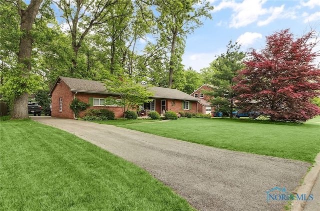 2742 Sandalwood Ave, Toledo, OH 43614 - ranch-style house with brick siding, a front lawn, and driveway