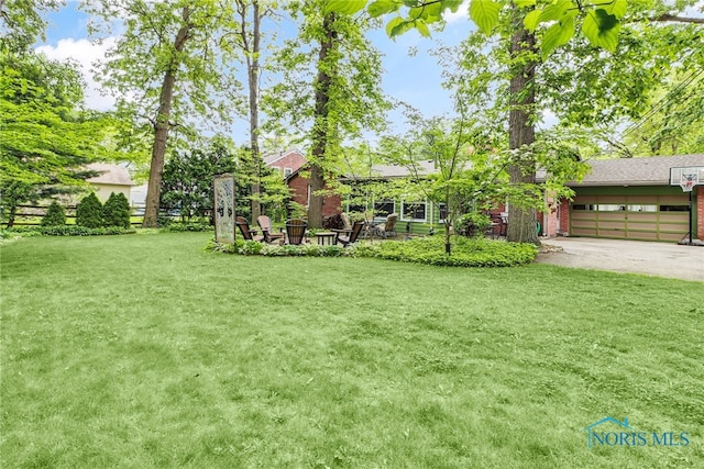 2742 Sandalwood Ave, Toledo, OH 43614 - view of grassy yard featuring driveway and an attached garage