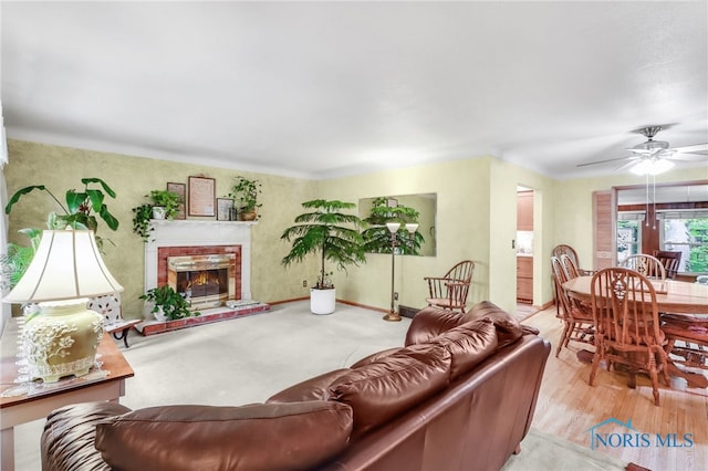 2742 Sandalwood Ave, Toledo, OH 43614 - living room featuring ceiling fan, a brick fireplace, and baseboards