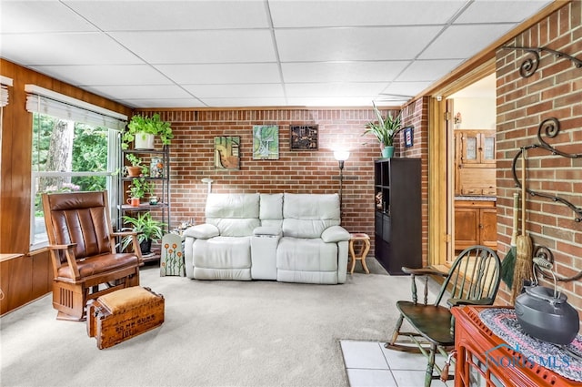 2742 Sandalwood Ave, Toledo, OH 43614 - living room with carpet, wood walls, brick wall, and a drop ceiling