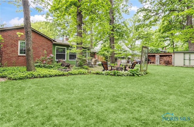 2742 Sandalwood Ave, Toledo, OH 43614 - view of yard with a patio and an outdoor fire pit