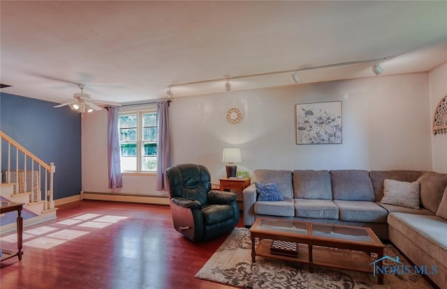 540 Center St, Findlay, OH 45840 - living area featuring a baseboard radiator, wood finished floors, stairway, rail lighting, and a ceiling fan