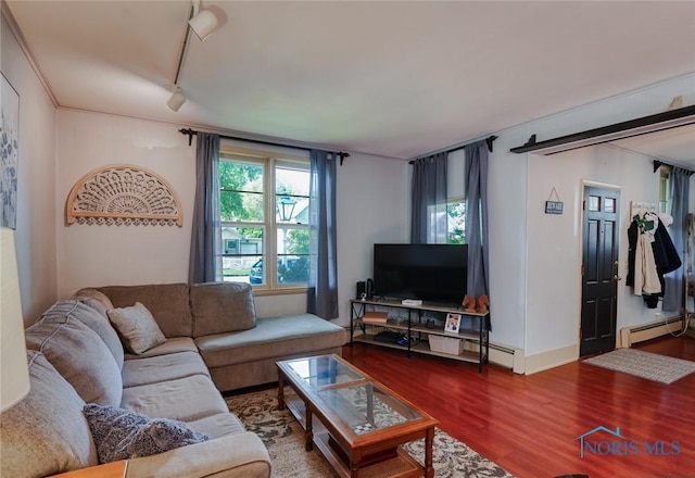 540 Center St, Findlay, OH 45840 - living area featuring a baseboard radiator, wood finished floors, and rail lighting