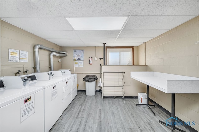 6640 Salisbury Rd Unit 212, Maumee, OH 43537 - communal laundry room featuring independent washer and dryer, light wood-style flooring, and concrete block wall