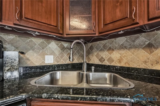 6640 Salisbury Rd Unit 212, Maumee, OH 43537 - detailed view of backsplash, glass insert cabinets, and dark stone countertops