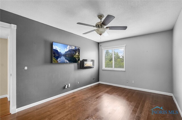 6640 Salisbury Rd Unit 212, Maumee, OH 43537 - unfurnished room with wood finished floors, a ceiling fan, and a textured ceiling