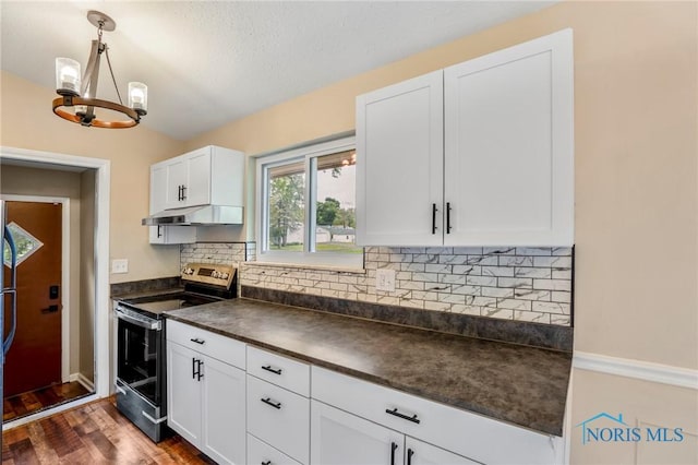 1765 Newport Ave, Toledo, OH 43613 - kitchen featuring stainless steel range with electric cooktop, dark countertops, under cabinet range hood, a chandelier, and white cabinets